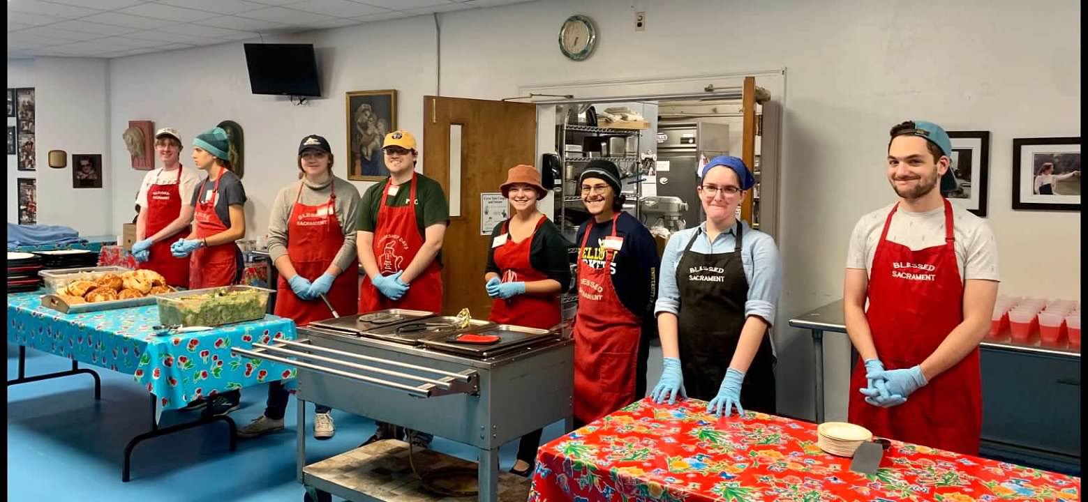 students serving at soup kitchen